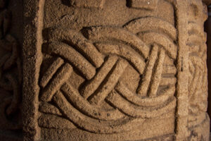 Carving on the font at Llangristiolus.