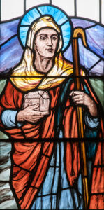 Image of St Teilo in stained glass.